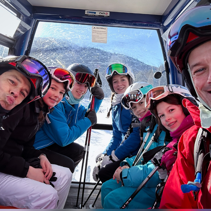 group of snowboarders in a ski lift