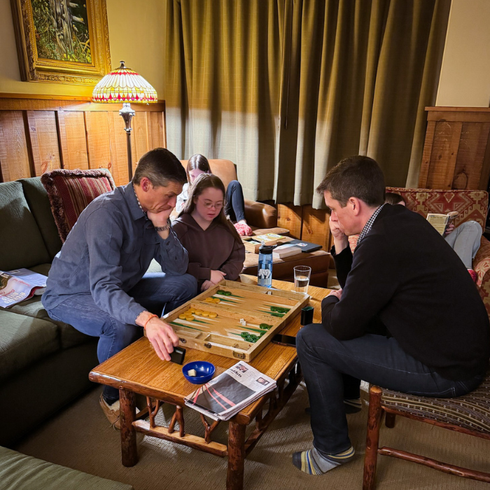 Peter, Penny, and Penny's uncle play Backgammon in a living room