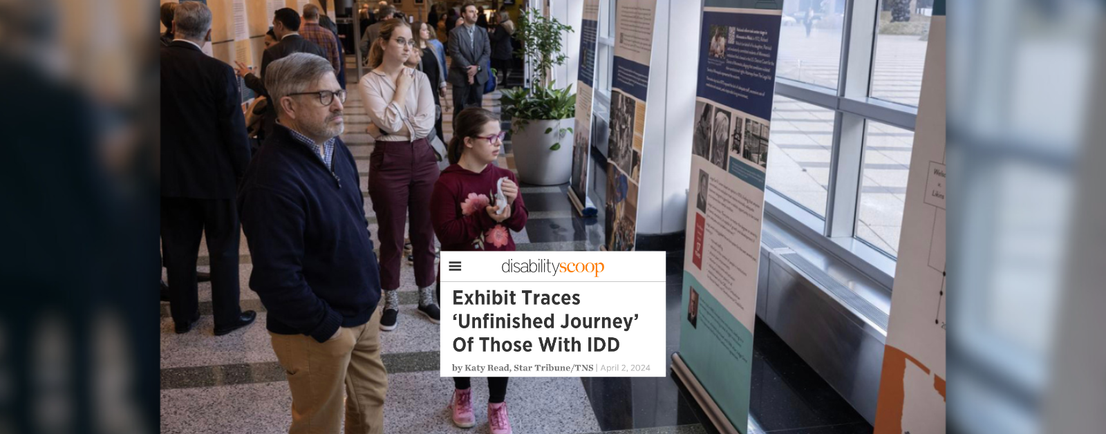 Screenshot of the cover of the article “Exhibit Traces ‘Unfinished Journey’ Of Those With IDD “. Lee Shervheim, left and his daughter Emie Shervheim 20, look over the exhibit "An Unfinished Journey" in the Federal Courts lobby of the U.S. Courthouse in Minneapolis. (Jerry Holt/Star Tribune/TNS)
