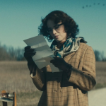 creenshot of Flannery O'Connor reading a letter by a mailbox from the Wildcat movie trailer