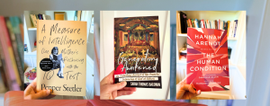 blurred bookshelves in the background with three book photos featured of: A Measure of Intelligence, Generation Awakened, and The Human Condition