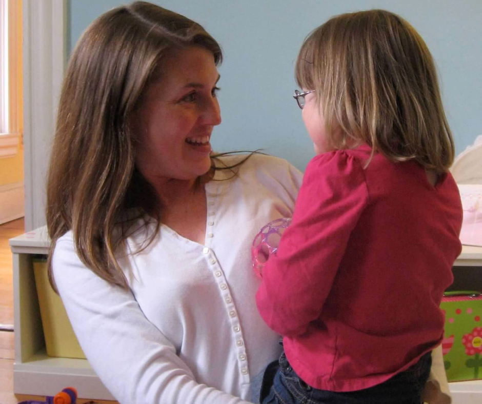 photo of Amy Julia holding toddler Penny. They are looking at each other and smiling