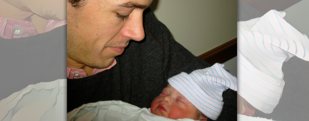 Peter looks down at baby Penny in his arms soon after he found out she had Down syndrome. She is wearing a slightly askew, striped hat