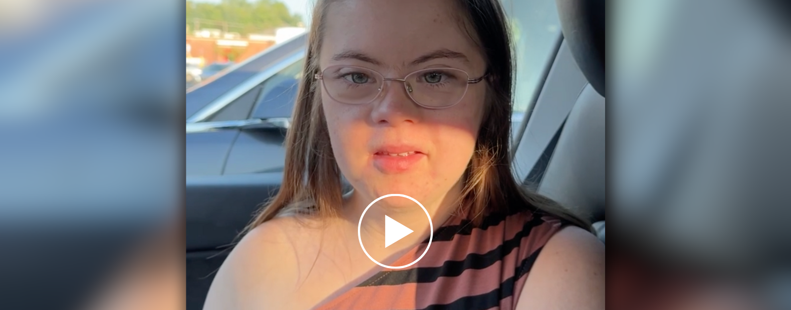 Penny looks at the camera as we sit in the car and I record her initial thoughts about starting college. Over the photo is a white play-button graphic