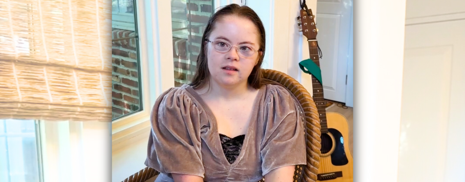 Penny sits in a chair by a window. She is talking to Amy Julia about her first weeks of college.