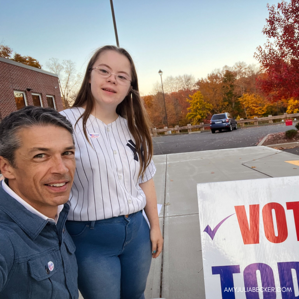 Peter and Penny take a selfie outside by a Vote Today sign