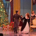 Penny dances with a partner on stage for The Nutcracker