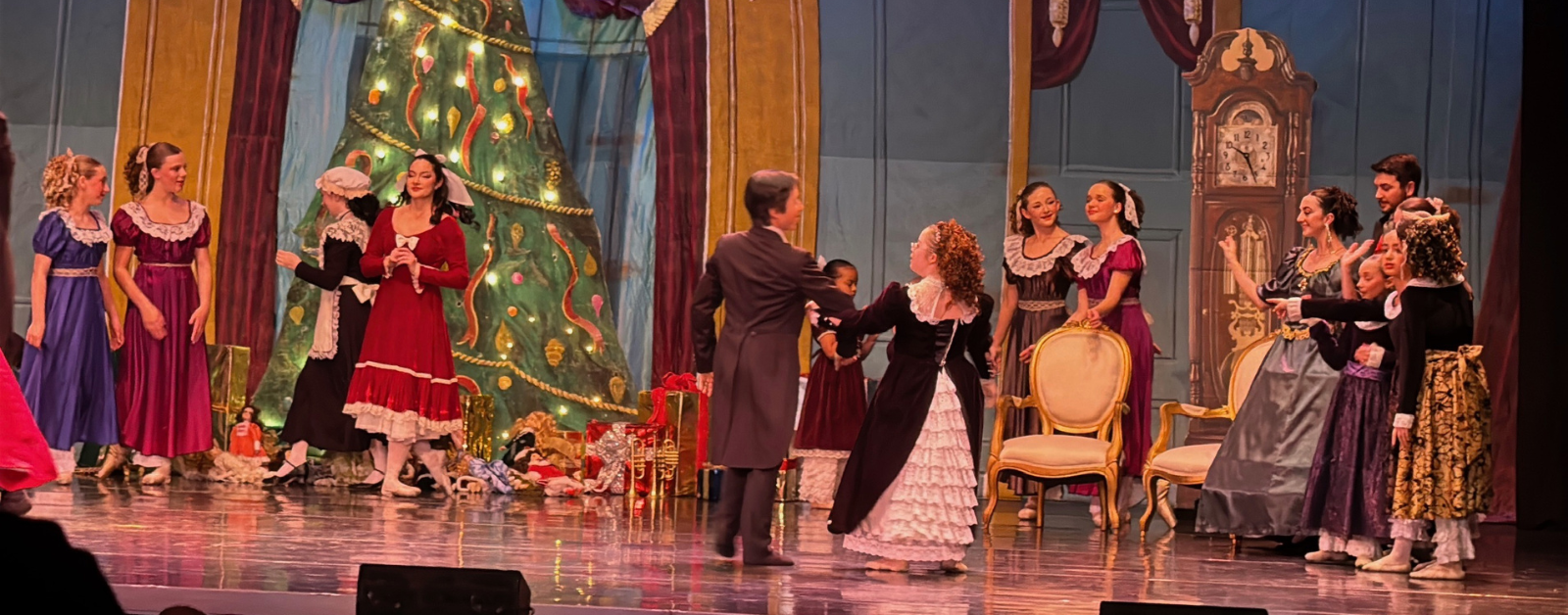 Penny dances with a partner on stage for The Nutcracker