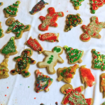 a 2016 photo of an assortment of Christmas cookies, decorated by our children, on a table with a white tablecloth