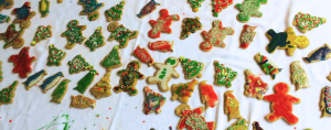 a 2016 photo of an assortment of Christmas cookies, decorated by our children, on a table with a white tablecloth