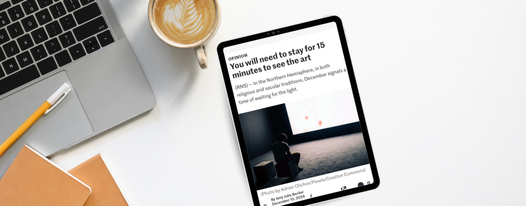 an ipad on a desk next to a cup of coffee and a keyboard. An essay is on the ipad screen.