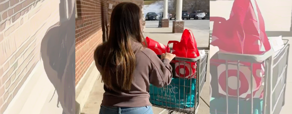 Penny pushes a shopping cart full of Target bags toward the parking lot