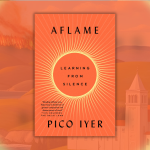 The image shows the cover of a book titled "Aflame: Learning from Silence" by Pico Iyer. The cover has an orange and red color scheme with a radiating circular design in the center. The background behind the book cover is a scenic landscape featuring rolling hills, a body of water, a burning forest, and a monastery or church building, all enveloped in warm orange tones, symbolizing the theme of fire or intensity suggested by the title.