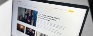 A close-up photograph of a laptop screen displaying an online news article. The article's headline reads, "The Trump administration's rhetoric about disability diminishes us all." The page features an image of former U.S. President Donald Trump speaking at a podium, with other smaller images below.