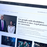 A laptop screen displays a WBUR article titled "For people with disabilities: Kindness is nice. Legal protections are necessary." The article includes a photo of former President Donald Trump and two other individuals. The article discusses how the Trump administration's policies impact people with disabilities and highlights the importance of legal protections over mere kindness.