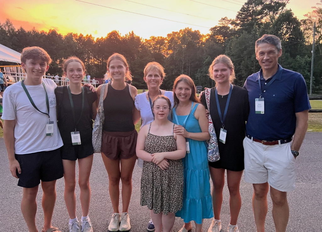 family with friends at Hope Heals Camp with a sunset behind us
