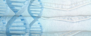 Stack of light blue denim jeans overlaid with a transparent image of DNA double helix strands.