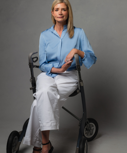 Katherine Wolf sitting on a walker chair