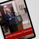 Tablet on a desk displays a video of former President Donald Trump speaking at a podium with the presidential seal. Another person stands behind him. A red news ticker partially visible at the bottom reads '…ges link between Tylenol an…'. Notebooks and folders are arranged on the desk next to the tablet.