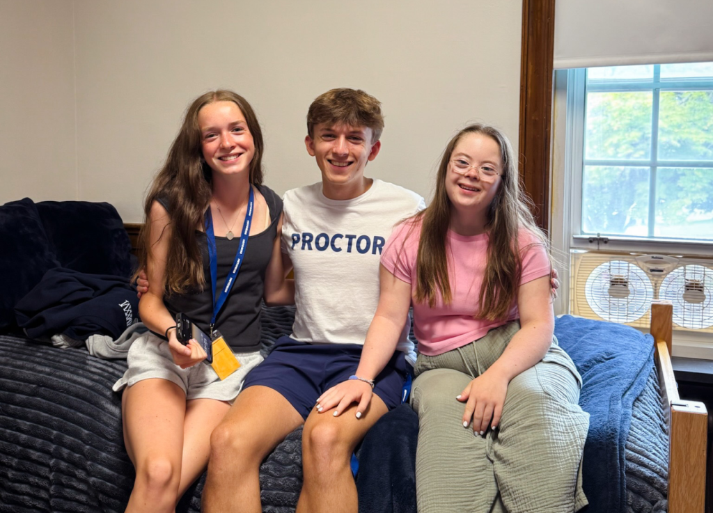 Marilee, William, and Penny sit on a bed in the dorm room at boarding school.
