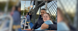 Peter and Penny sit on bleachers together