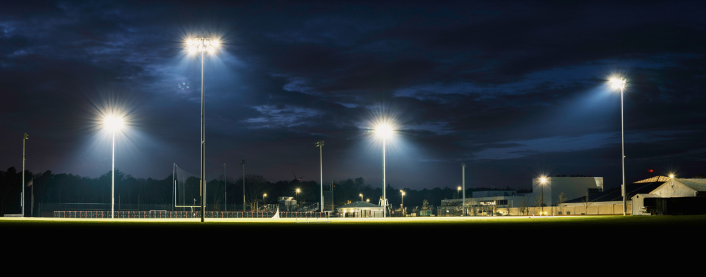 Empty small town high school football ground lighted at night