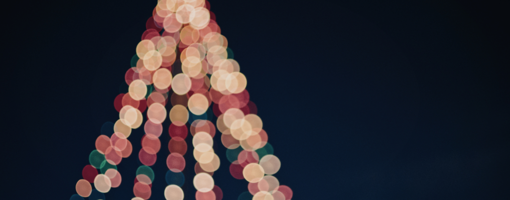 blurred Christmas lights on a Christmas tree against a dark background