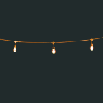 lights strung between poles on a dark night