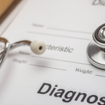 Medical diagnosis form on a clipboard with a stethoscope on top