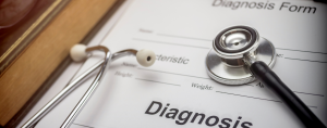 Medical diagnosis form on a clipboard with a stethoscope on top