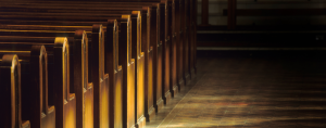 empty church pews in a dark church