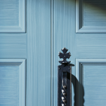 photo of a blue closed door with shadows across it