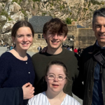 Marilee, William, Penny, and Peter posing outside for a photo in France on our 2026 spring break trip