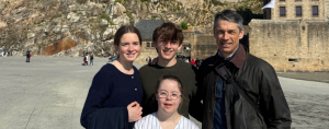Marilee, William, Penny, and Peter posing outside for a photo in France on our 2026 spring break trip