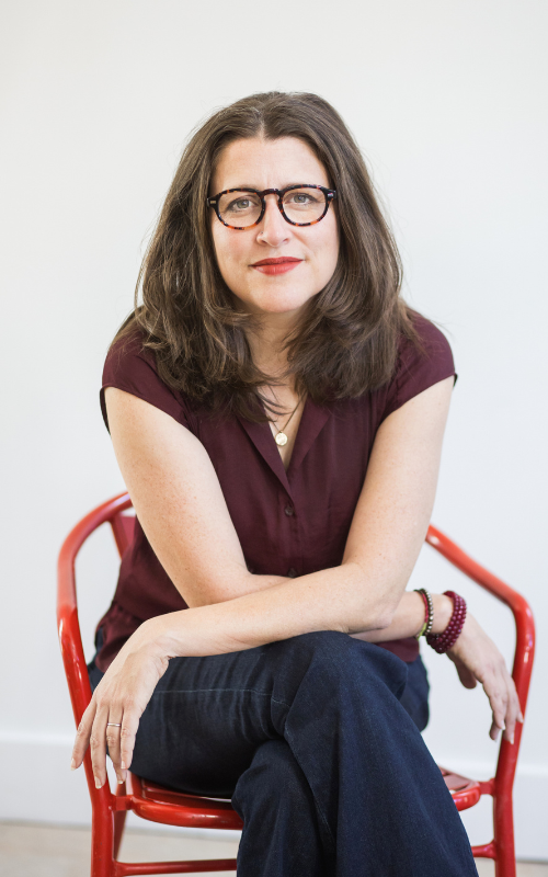 indoor portrait of Tish Harrison Warren sitting in a red chair
