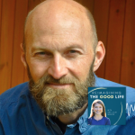 Brian Brock, PhD smiles for portrait. In the lower right corner is the logo of the “Reimagining the Good Life with Amy Julia Becker” podcast, along with a white audio waveform graphic.