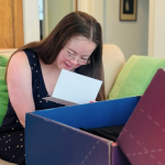 Penny, who has Down syndrome, reads a note that accompanied a surprise gift box from Delta Air Lines for her first solo flight.