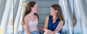 Marilee and I sit on steps, look at each other, and laugh together.