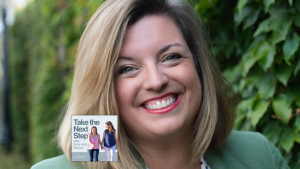 Misty Coy Snyder poses for a portrait outside. In the lower left is the cover of the “Take the Next Step with Amy Julia Becker” podcast with Penny, who has Down syndrome, walking with Amy Julia on a dirt path.