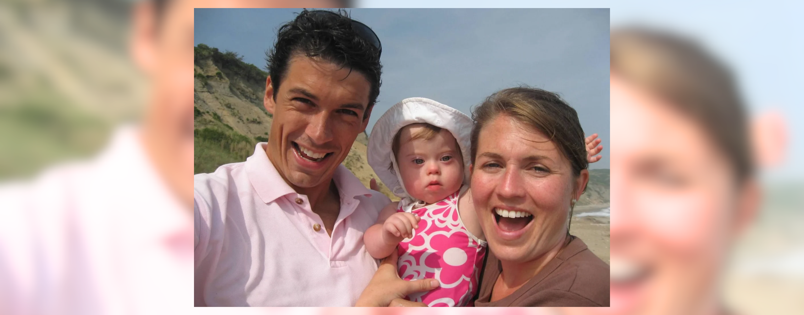 2007 photo of Peter and me with huge smiles, holding baby Penny at the beach