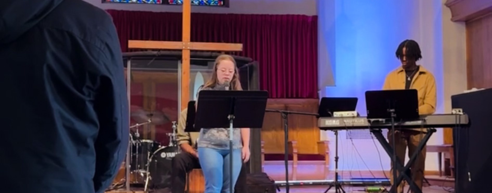 2024 photo of Penny leading our church in the Lord’s Prayer during the worship service