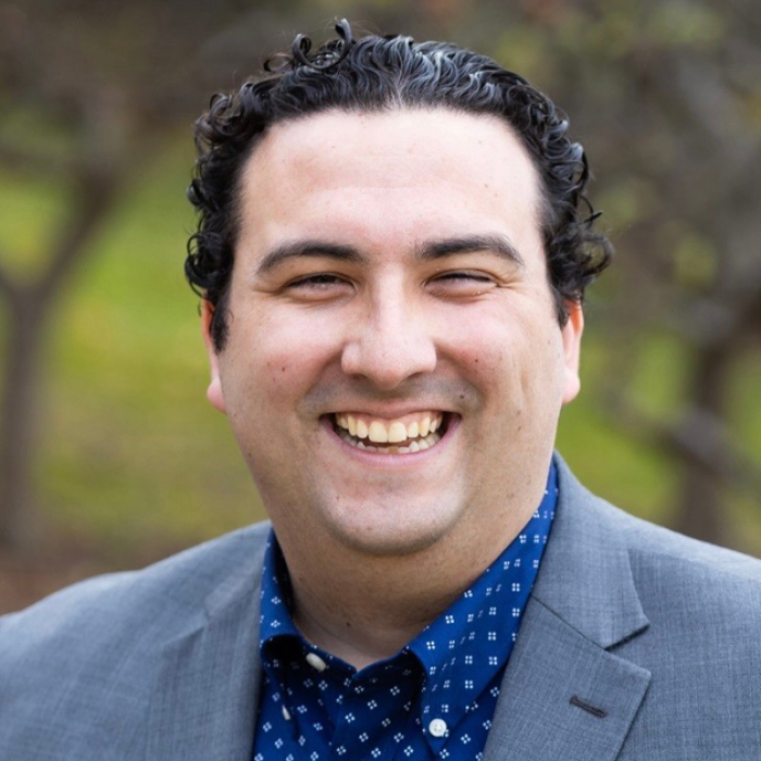 AJB-featured season 7(1560 × 628 px) – wear dark blue graphic with intertwined blue and yellow partial circles on the left and text that says: Reimagining the Good Life with Amy Julia Becker. In the middle of the graphic is a a photo Michael Wear. On the far right is a photo of Amy Julia.