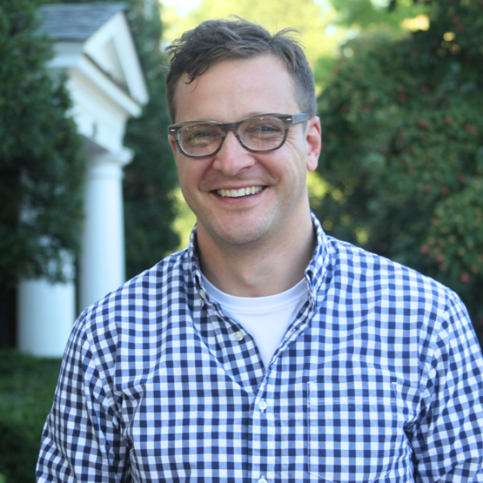 AJB-featured season 8 corey widmer how to be a christian during election season dark blue graphic with geometric shape overlays and the Reimagining the Good Life with Amy Julia Becker podcast logo in bottom right corner. In the middle of the graphic is a photo of Corey Widmer