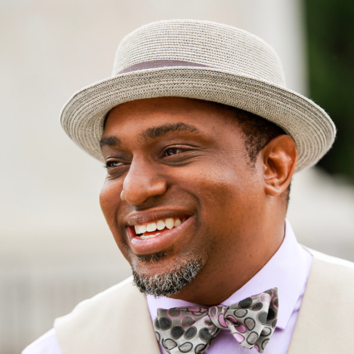 AJB-featured season 8 david bailey dark blue graphic with geometric shape overlays and the Reimagining the Good Life with Amy Julia Becker podcast logo in bottom right corner. In the middle of the graphic is a photo of David M. Bailey