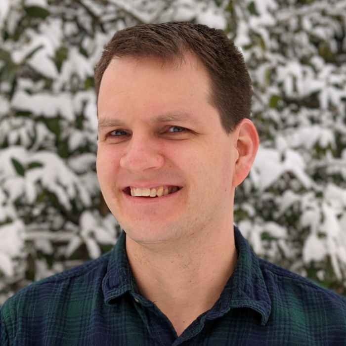 AJB-featured season 8 dr matthew loftus dark blue graphic with geometric shape overlays and the Reimagining the Good Life with Amy Julia Becker podcast logo in bottom right corner. In the middle of the graphic is a photo of Dr Matthew Loftus